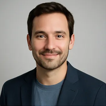 A professional headshot of Tom, the author, a smiling man with dark hair and a beard.